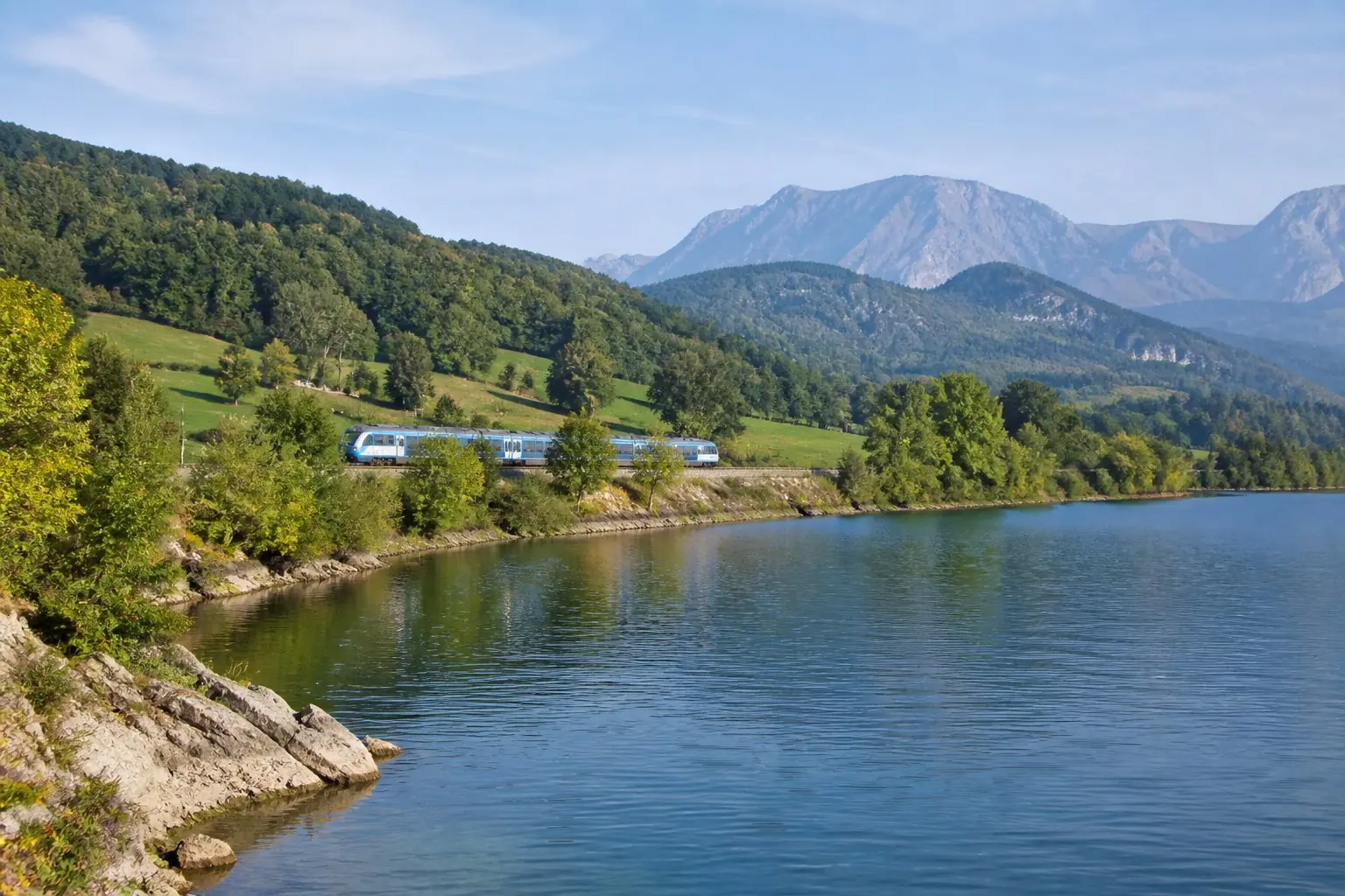 Lac et reliefs alpins en Auvergne-Rhône-Alpes avec un train régional